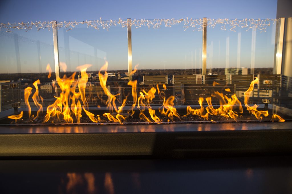 A fire table is seen on the Vue rooftop during a ribbon cutting event for the Hilton Garden Inn on Clinton Street on Thursday, Nov., 30, 2017. The 12th floor of the hotel features a rooftop bar and restaurant that is open to the public. The hotel opened in October. (Joseph Cress/The Daily Iowan)