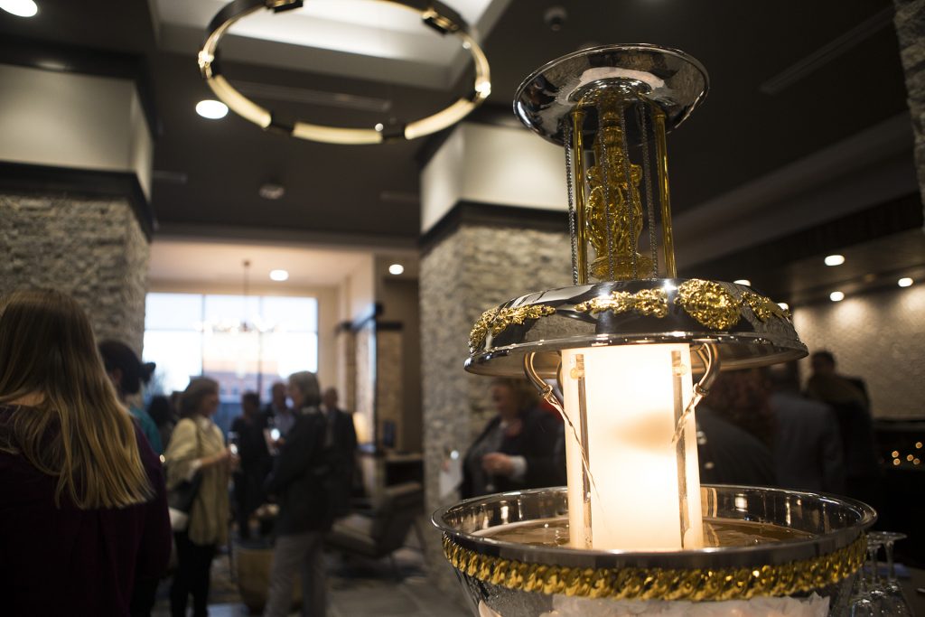 A champagne fountain flows in the lobby during a ribbon cutting event for the Hilton Garden Inn on Clinton Street on Thursday, Nov., 30, 2017. The 12th floor of the hotel features a rooftop bar and restaurant that is open to the public. The hotel opened in October. (Joseph Cress/The Daily Iowan)