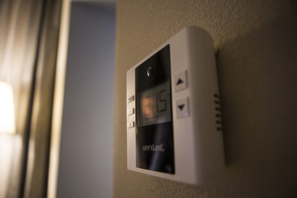 A room temperature control shows Celsius and Fahrenheit controls during a ribbon cutting event for the Hilton Garden Inn on Clinton Street on Thursday, Nov., 30, 2017. The 12th floor of the hotel features a rooftop bar and restaurant that is open to the public. The hotel opened in October. (Joseph Cress/The Daily Iowan)
