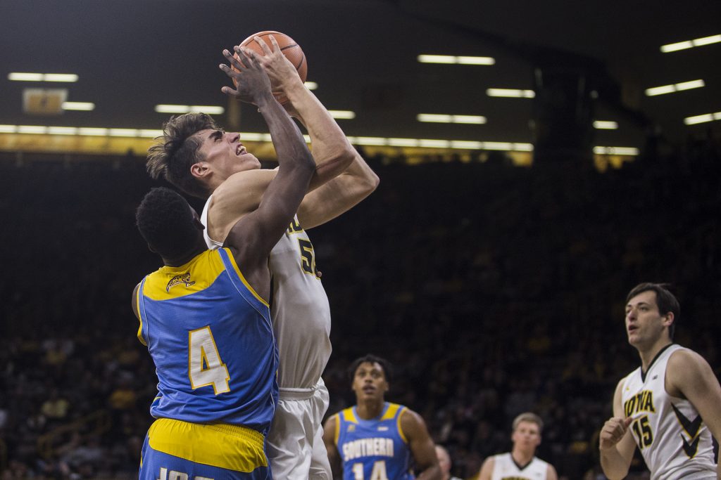 Iowa forward Luke Garza (55) drives the ball against Southerns Chris Thomas (4) during the game between Iowa and Southern at Carver-Hawkeye Arena on Sunday, Dec. 10. 