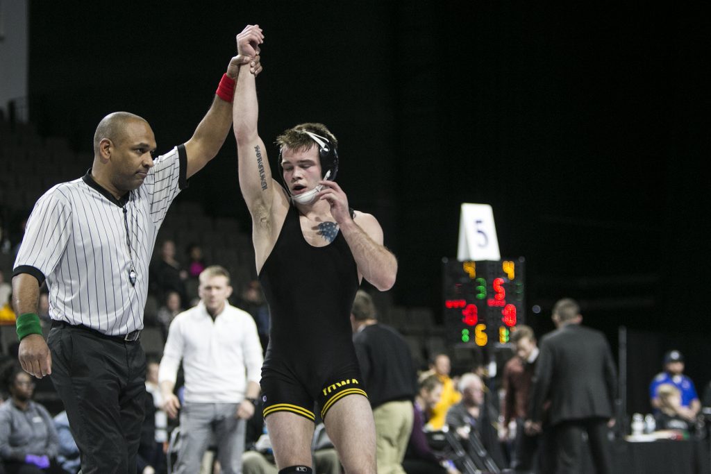 Iowas 149-pound Brandon Sorensen has his arm raised after winning during the fourth session of the 55th Annual Midlands Championships in the Sears Centre in Hoffman Estates, Illinois, on Saturday, Dec. 30, 2017. (Joseph Cress/The Daily Iowan)