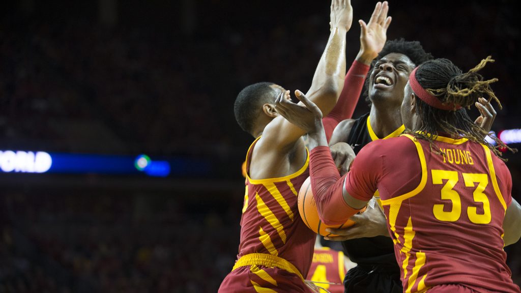 Iowa forward Tyler Cook is blocked by Iowa State's Soloman Young (33) and Jeff Beverly (55) during the Iowa Corn CyHawk Series men's basketball game at Hilton Coliseum in Ames on Thursday, Dec. 7, 2017. The Cyclones defeated the Hawkeyes, 84-78. (Lily Smith/The Daily Iowan)