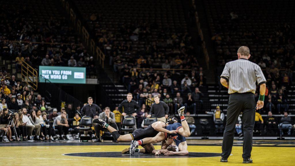 Iowa wrestler Michael Kemerer wrestles against Illinois’ Kyle Langenderfer during a meet at Carver Hawkeye Arena on Friday, Dec. 1, 2017. The Hawkeyes defeated the Illini 18-17. (Nick Rohlman/The Daily Iowan)