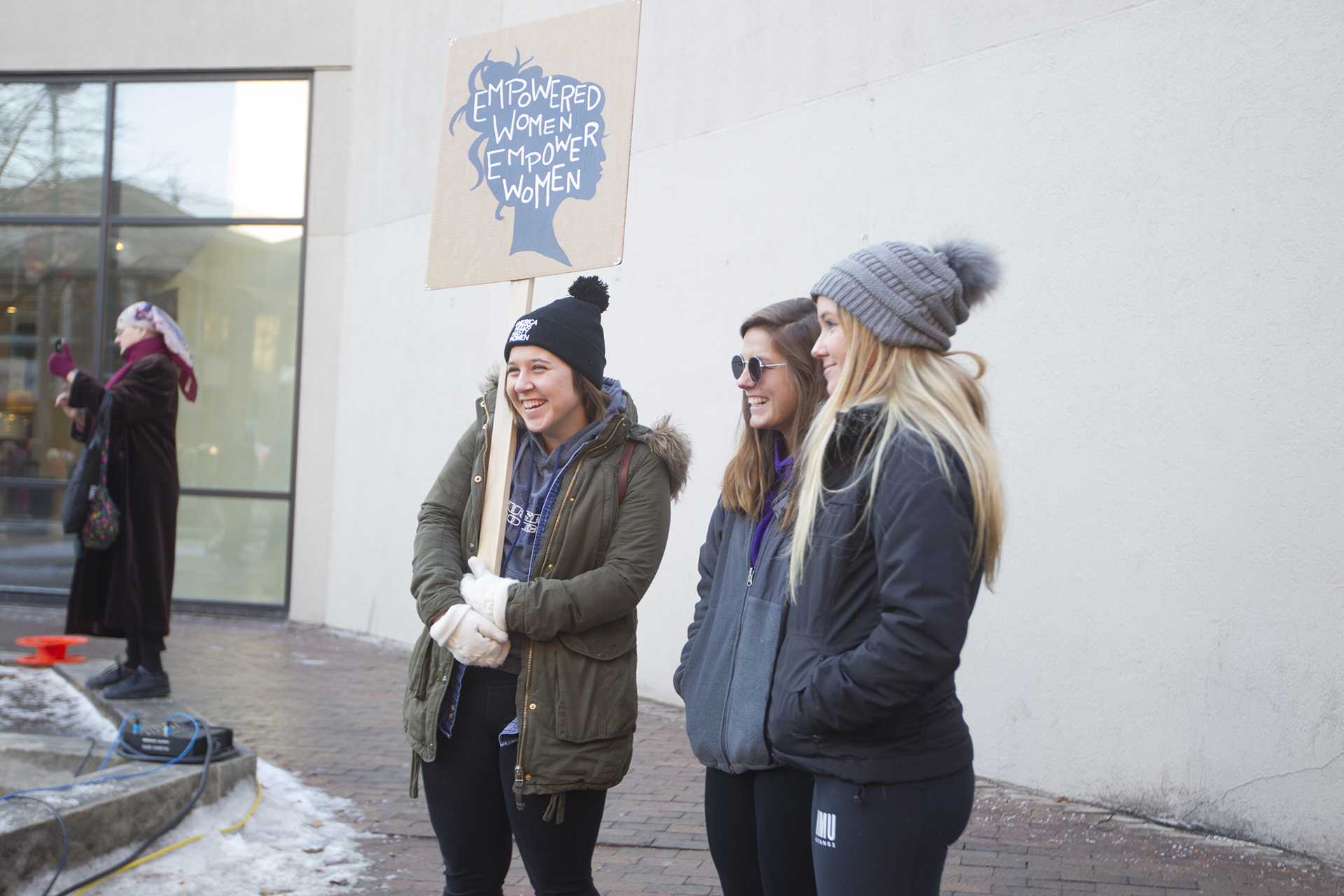 Students smile during the Womens March on January 20, 2018. Hundreds gathered on the Ped Mall to listen to speakers and march for womens rights. (Katie Goodale/The Daily Iowan)