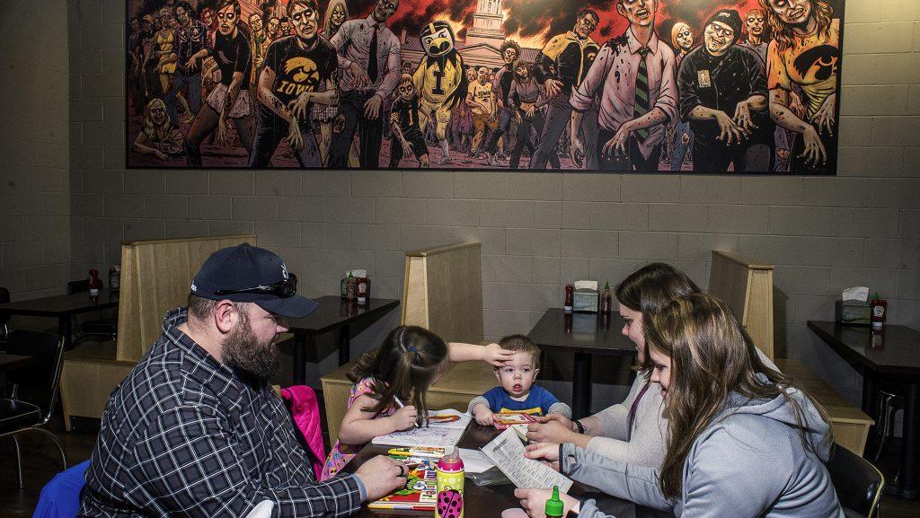 The Ashby family dines at Zombie Burger for the first time at the Iowa City location on Monday, Jan. 22, 2017. The family likes to support smaller business and make an effort to dine out every couple weeks. (James Year/The Daily Iowan)