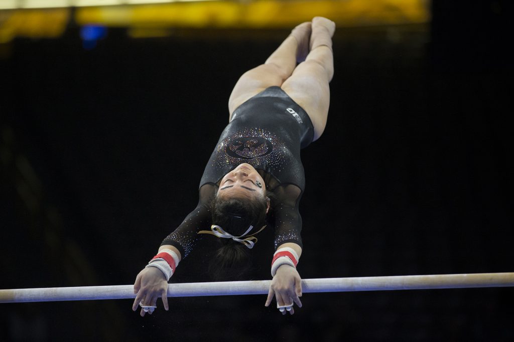 Iowa's Clair Kaji performs on the uneven bars during the Iowa/Ohio State gymnastics meet in Carver-Hawkeye Arena on Friday, Jan. 19, 2018. The GymHawks defeated the Buckeyes, 195.725 to 195.300, to win their home opener. (Lily Smith/The Daily Iowan)