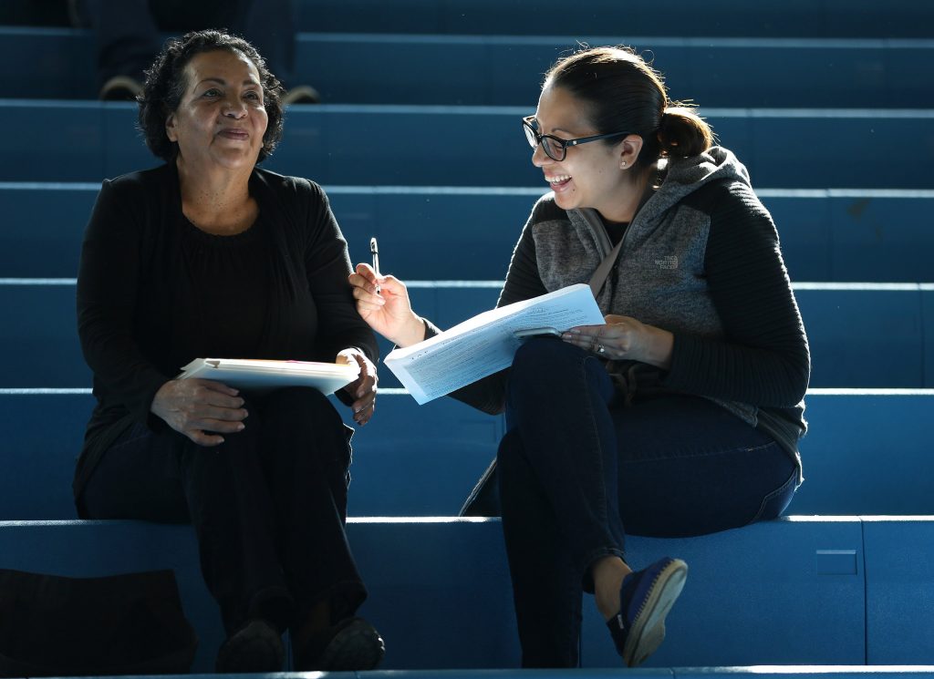 Maria Garcia, left, gets help with her paperwork from her daughter, Sonia Hernandez, during a U.S. citizenship application workshop at Daley College in Chicago on April 16,  2016. (Abel Uribe/Chicago Tribune/TNS)
