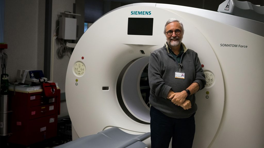 University of Iowa professor, Dr. Eric Hoffman, stands in front of a powerful CT scanner in his lab on Tuesday, Jan. 30, 2018. Dr. Hoffman is the director of the Advanced Pulmonary Physiomic Imaging Laboratory. (Matthew Finley/The Daily Iowan)