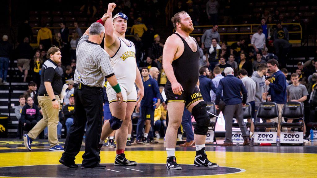 Iowas 285 pound Sam Stoll walks off the mat after losing his match to Michigan wrestler Adam Coon at Carver-Hawkeye Arena on Saturday, Jan. 27, 2018. The Wolverines defeated the Hawkeyes 19-17. (David Harmantas/The Daily Iowan)
