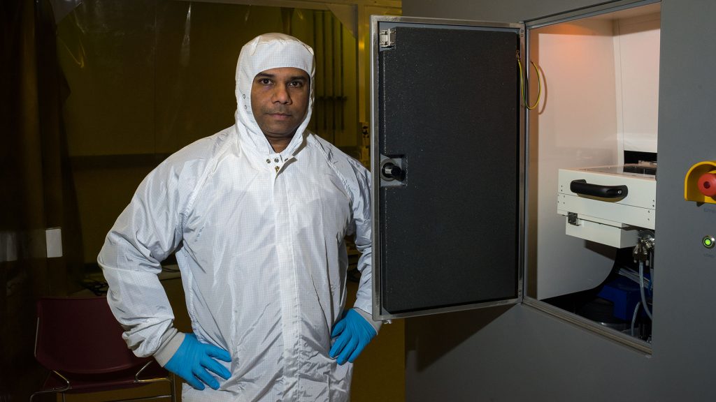 Dr. Aju Jugessur stands in front of one of the machines used in his lab at the Iowa Advanced Technology Laboratory on Tuesday, Jan. 23, 2018. Dr. Jugessur is the director of the University of Iowa Microfabrication Facility.