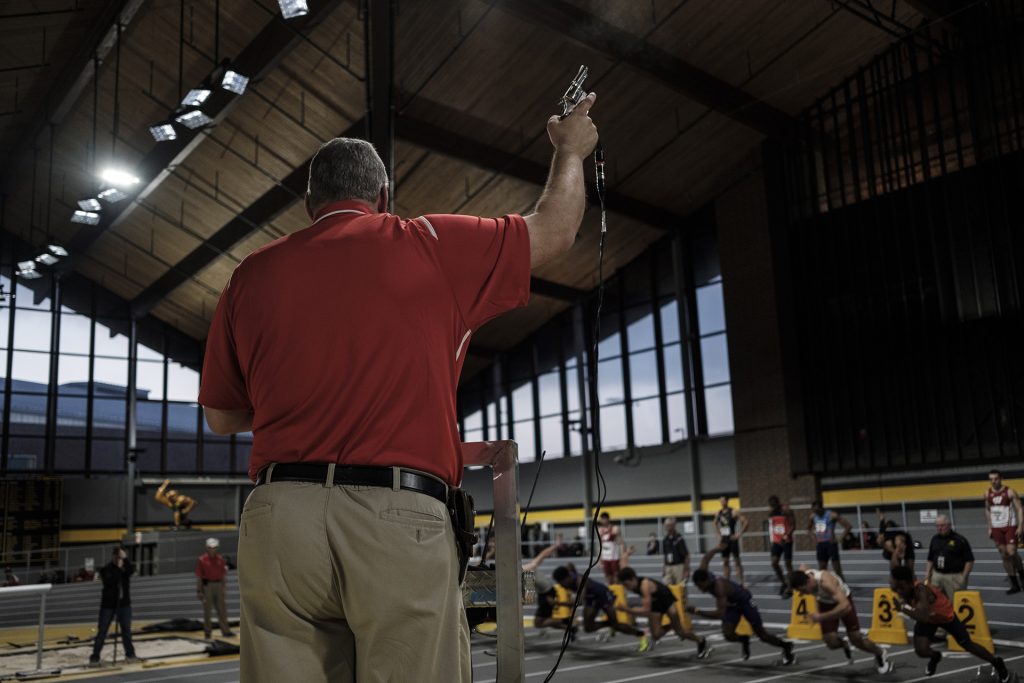 An official fires the starters gun during the Larry Wieczorek Invitational on Saturday, Jan. 20, 2017. (Nick Rohlman/The Daily Iowan)