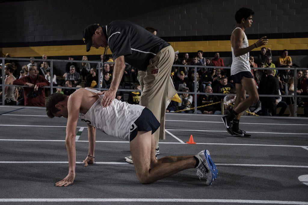 An official comforts an athlete after a race during the Larry Wieczorek Invitational on Saturday, Jan. 20, 2017. (Nick Rohlman/The Daily Iowan)