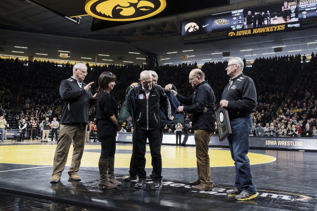 Longtime Cornell College and USA Wrestling coach Mike Duroe is honored with a Lifetime Service to Wrestling award. presented to him by Dan Gable on behalf of the National Wresling Hall of Fame. (Nick Rohlman/The Daily Iowan)