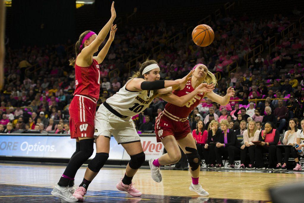 Iowa forward Megan Gustafson and Wisconsin guard Lexy Richardson dive for the ball during the Iowa/Wisconsin basketball game at Carver-Hawkeye Arena on Sunday, Feb. 18, 2018. The Hawkeyes defeated the Badgers, 88-61. (Lily Smith/The Daily Iowan)