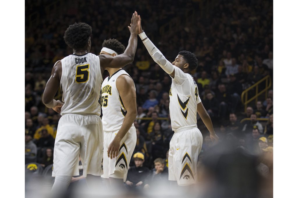 Iowas Isaiah Moss (right) and Tyler Cook (left) high five during the Senior Day mens basketball game between Iowa and Northwestern at Carver-Hawkeye Arena on Sunday, Feb. 25, 2018. The Hawkeyes defeated the Wildcats 77-70. (Ben Allan Smith/The Daily Iowan)