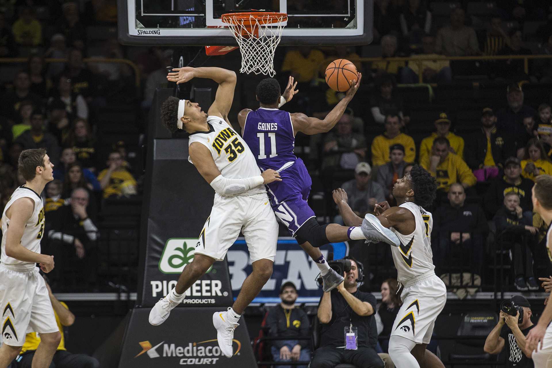 Iowas Cordell Pemsl (35) attempts to block a shot by Northwesterns Anthony Gaines (11) during the Senior Day mens basketball game between Iowa and Northwestern at Carver-Hawkeye Arena on Sunday, Feb. 25, 2018. The Hawkeyes defeated the Wildcats 77-70. (Ben Allan Smith/The Daily Iowan)