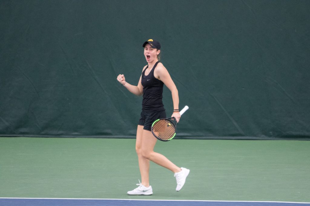 Iowa tennis player Elise van Heuvelen celebrates winning a match during a match against Marquette University on Sunday, Feb. 25, 2018 at the Hawkeye Tennis Complex. 