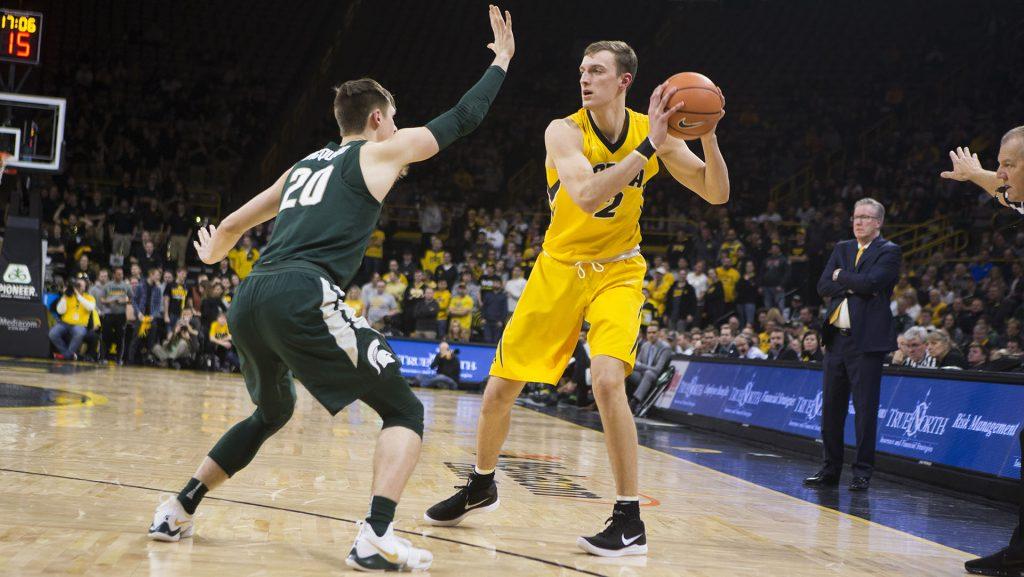 Iowa F Jack Nunge faces off with Michigan State G Matt McQuaid (20) during a basketball game between Iowa and Michigan State at Carver-Hawkeye Arena on Tuesday, Feb. 6, 2018. The Hawkeyes were defeated by the visiting Spartans, 96-93. (Shivansh Ahuja/The Daily Iowan)