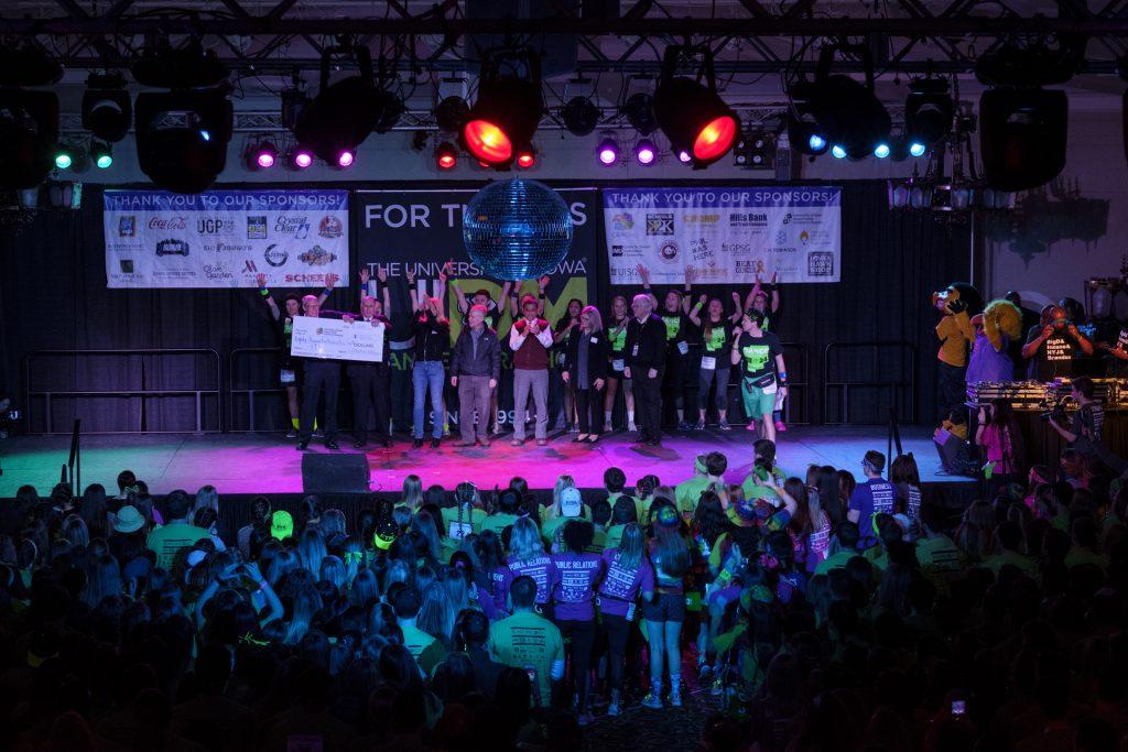 Representatives from the University of Iowa Children's Hospital and I Heart Radio present a check from a radio fundraiser during Dance Marathon 24 at the Iowa Memorial Union on Friday, Jan. 28, 2018. Dance Marathon raises money for pediatric cancer research. (Nick Rohlman/The Daily Iowan)