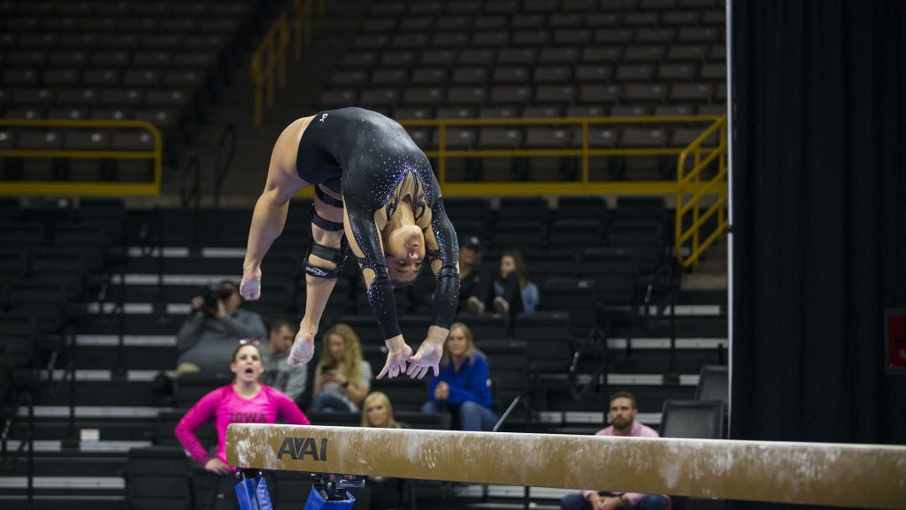 Iowas Rose Piorkowski performs on the beam during the Iowa/Ball State gymnastics meet at Carver-Hawkeye Arena on Friday, Feb. 16, 2018. Pierkowski scored a 1.000 after suffering an injury. The GymHawks defeated the Cardinals, 195.775-194.825. (Lily Smith/The Daily Iowan)