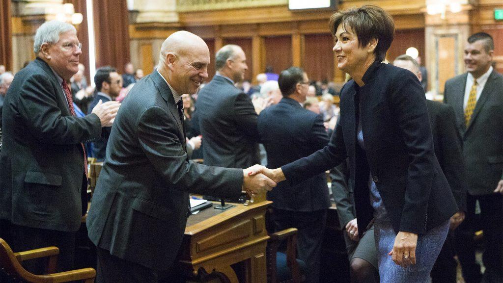 Iowa Gov. Kim Reynolds shakes hands with after Rep. Dave Jacoby, D-Coralville, while Sen. Robert E. Dvorsky, D-Coralville, claps after her first Condition of the State address in the Iowa State Capitol in Des Moines on Tuesday, Jan. 9, 2018. Reynolds took over the governor office in May of 2017. (Joseph Cress/The Daily Iowan)