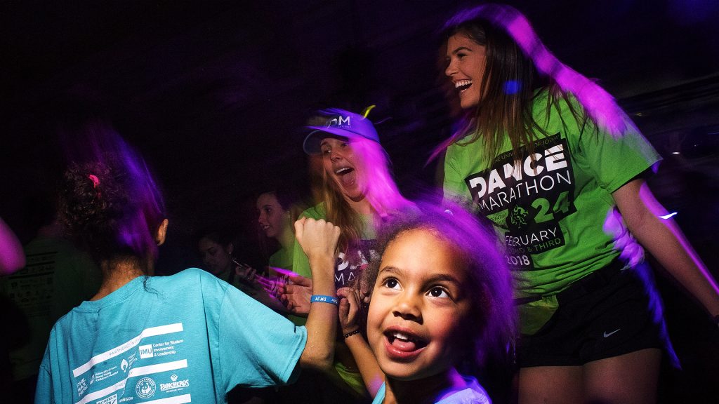 A+child+dances+with+her+newfound+friends%2C+Patty+Pochocki+%28left%29+and+Jordyn+Boge+%28right%29+during+the+annual+UI+Dance+Marathon+fundraiser+at+the+IMU+on+Friday%2C+Feb.+2%2C+2018.+%28James+Year%2FThe+Daily+Iowan%29