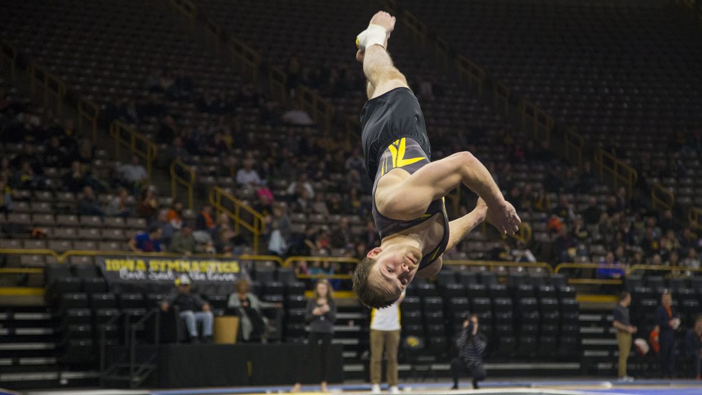Iowas Dylan Ellsworth performs on the floor during the Iowa/Illinois mens gymnastics meet at Carver-Hawkeye Arena on Saturday, Feb. 3, 2018. Ellsworth scored a 13.350 on floor. The Fighting Illini defeated the Hawkeyes, 404.700-401.850, to lose their home opener. (Lily Smith/The Daily Iowan)
