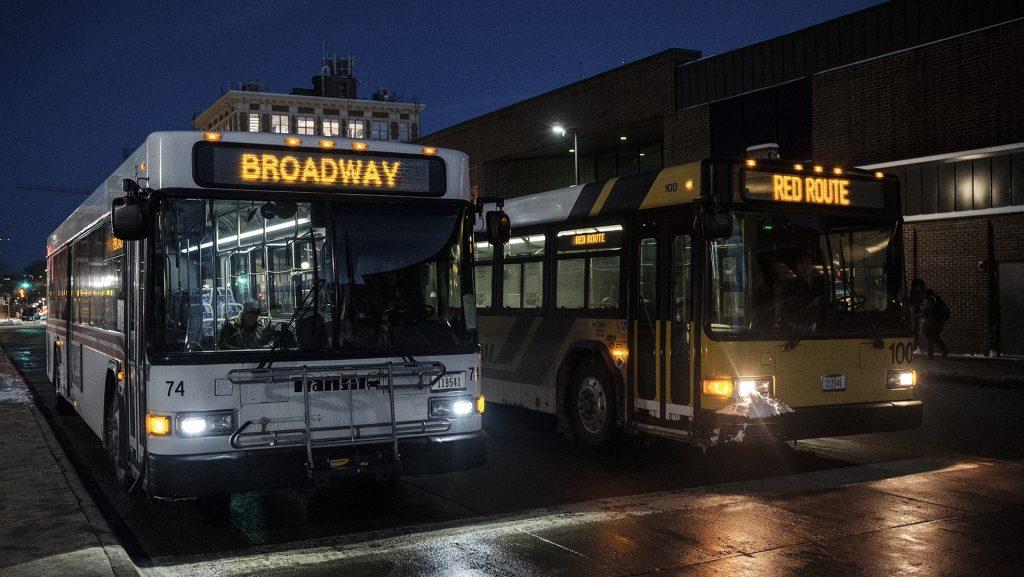 Commuters load and unload buses at the Downtown interchange in Iowa City on Wednesday, Feb. 7, 2018. 