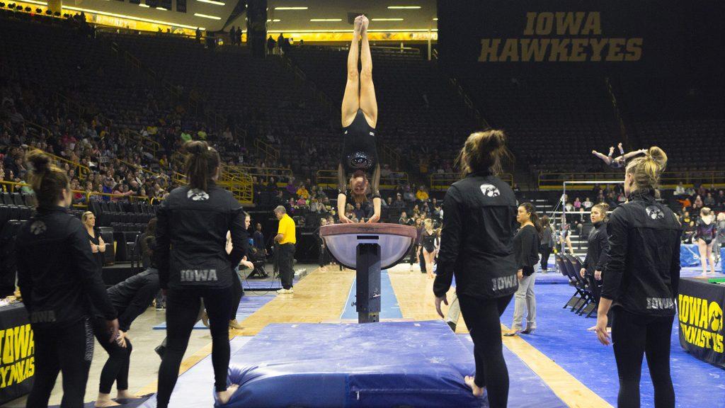 An Iowa gymnast warms up on the vault during the Iowa/Ohio State gymnastics meet in Carver-Hawkeye Arena on Friday, Jan. 19, 2018. The GymHawks defeated the Buckeyes, 195.725 to 195.300, to win their home opener. (Lily Smith/The Daily Iowan)