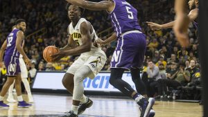 Iowa forward Tyler Cook drives the ball in the lane against Northwesterns Derek Pardon during the Senior Day mens basketball game between Iowa and Northwestern at Carver-Hawkeye Arena on Sunday, Feb. 25, 2018. The Hawkeyes defeated the Wildcats 77-70. (Ben Allan Smith/The Daily Iowan)