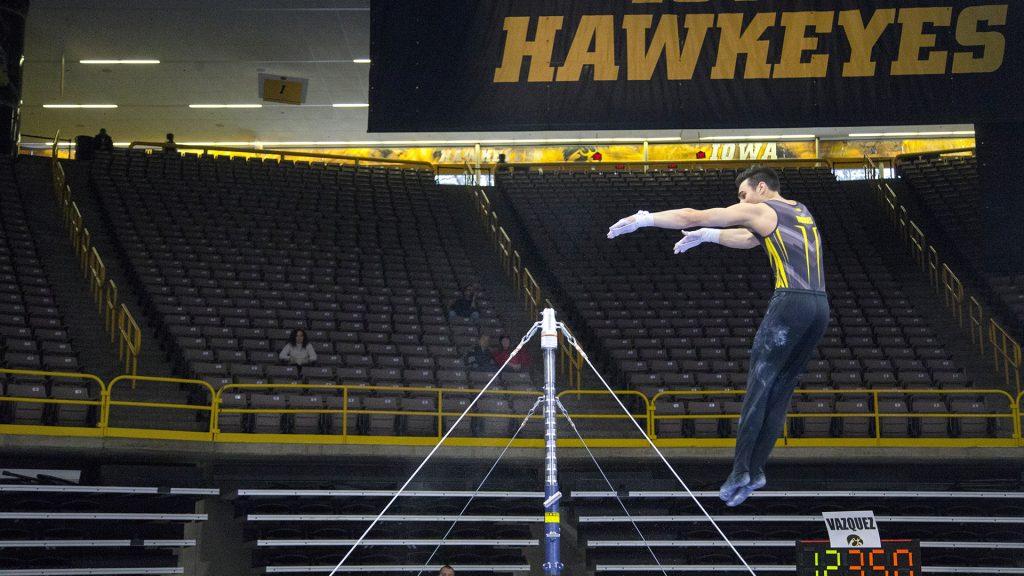 Iowas Austin Hodges performs on the bar during the Iowa/Illinois mens gymnastics meet at Carver-Hawkeye Arena on Saturday, Feb. 3, 2018. The Fighting Illini defeated the Hawkeyes, 404.700-401.850, to lose their home opener. (Lily Smith/The Daily Iowan)