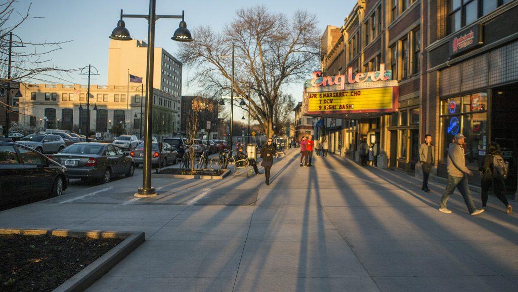 People walk the streets outside The Englert Theatre on Thursday, April 6, 2017. (Ben Allan Smith/The Daily Iowan)