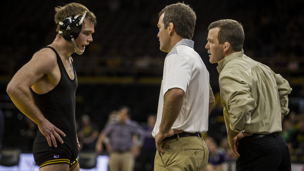 Iowa%E2%80%99s+number+2+ranked+159+pund+wrestler+Brandon+Sorenson+talks+to+head+coaches+Tom+and+Terry+Brands+during+the+Iowa+vs.+Northwestern+dual+meet+on+Sunday%2C+Feb.+4%2C+2018.+Sorenson+won+his+match+5-4+to+close+out+his+home+career+as+a+Hawkeye+and+the+Hawkeyes+defeated+the+wildcats+33-2.+%28Nick+Rohlman%2FThe+Daily+Iowan%29