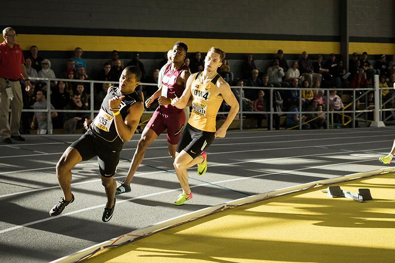 Iowas Collin Hofacker and other racers round a corner during the last heat of the 400 meter dash at the Black and Gold Premier on Jan. 27, 2018. Collin placed third with a time of 47.94. 