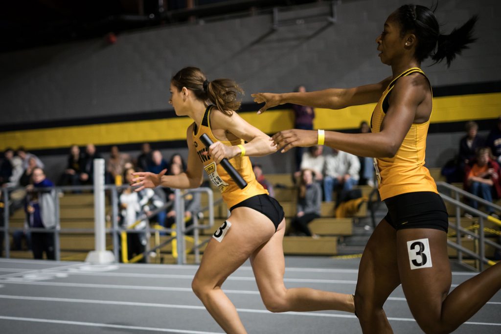 Iowas Tashee Hargrave passes the baton to Iowas anchor, Kylie Welch, during the 4x400 at the Black and Gold Premier on Jan. 27, 2018. Iowa placed first in the relay with a time of 3:45.13.  (Matthew Finley/The Daily Iowan)
