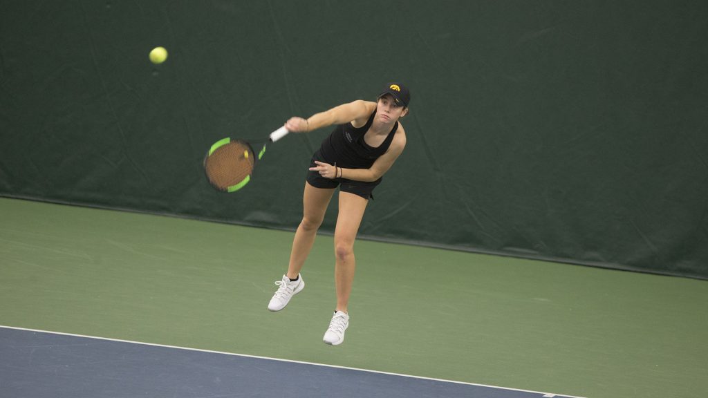 Iowa's Elise van Heuvelen serves during a tennis match between Iowa and Northern Iowa in Iowa City on Saturday, Jan. 20, 2018. The Hawkeyes defeated the Panthers, 7-0. (Shivansh Ahuja/The Daily Iowan)