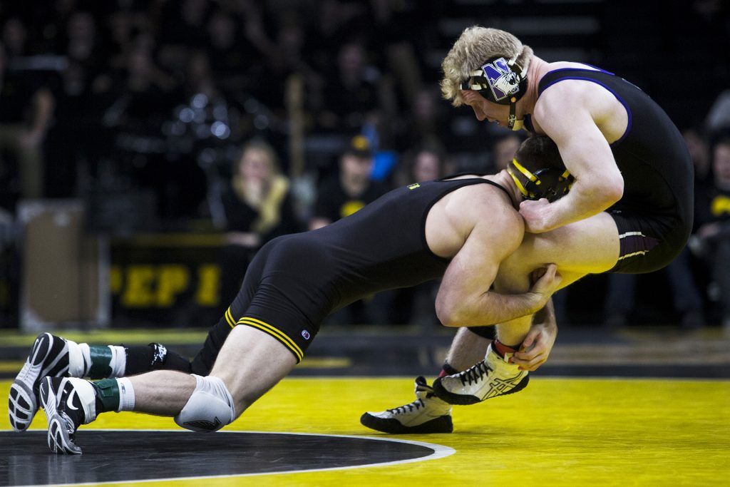 Iowas #7 ranked 165 pound Alex Marinelli takes down Northwesterns Michael Sepke during the Iowa vs. Northwestern dual meet on Sunday, Feb. 4, 2018. The Hawkeyes defeated the wildcats 33-2. (Nick Rohlman/The Daily Iowan)