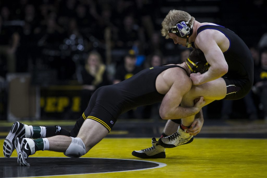 Iowas #7 ranked 165 pound Alex Marinelli takes down Northwesterns Michael Sepke during the Iowa vs. Northwestern dual meet on Sunday, Feb. 4, 2018. The Hawkeyes defeated the Wildcats, 33-2. (Nick Rohlman/The Daily Iowan)