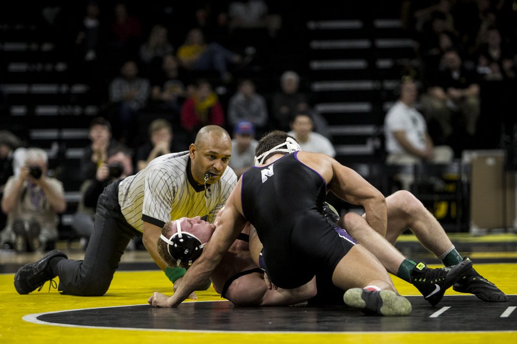 Northwestern's #17 ranked 174 pound Johnny Sebastian takes down Iowa's Kaleb Young during the Iowa vs. Northwestern dual meet on Sunday, Feb. 4, 2018. The Hawkeyes defeated the wildcats 33-2. (Nick Rohlman/The Daily Iowan)