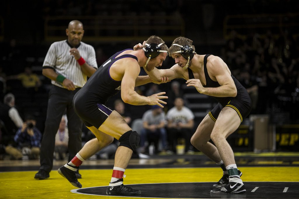 Iowa's #20 ranked 184 pound Mitch Bowman wrestles Northwestern's Mitch Sliga during the Iowa vs. Northwestern dual meet on Sunday, Feb. 4, 2018. The Hawkeyes defeated the wildcats 33-2. (Nick Rohlman/The Daily Iowan)