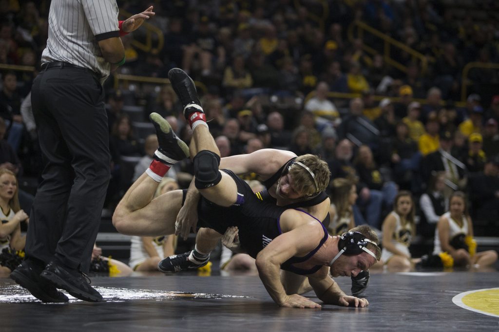 Iowa's #20 ranked 184 pound Mitch Bowman wrestles Northwestern's Mitch Sliga during the Iowa vs. Northwestern dual meet on Sunday, Feb. 4, 2018. The Hawkeyes defeated the wildcats 33-2. (Nick Rohlman/The Daily Iowan)