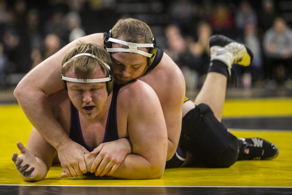 Iowa #3 ranked heavyweight Sam Stoll rides Northwestern's Conan Jennings during the Iowa vs. Northwestern dual meet on Sunday, Feb. 4, 2018. The Hawkeyes defeated the wildcats 33-2. (Nick Rohlman/The Daily Iowan)