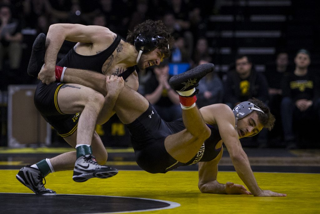 Iowa 141 pound wrestler Vince Turk takes down Northwestern's Alec McKenna during the Iowa vs. Northwestern dual meet on Sunday, Feb. 4, 2018. Turk won a major decision 10-2. The Hawkeyes defeated the wildcats 33-2. (Nick Rohlman/The Daily Iowan)