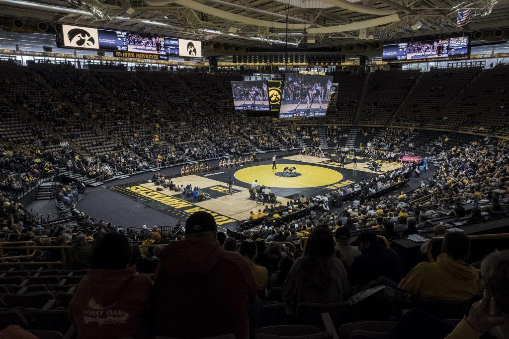 Fans+look+on+as+Iowas+133+pound+Paul+Glynn+wrestles+Northwesterns+%2320+ranked+Colin+Valdiviez+during+the+Iowa+vs.+Northwestern+dual+meet+on+Sunday%2C+Feb.+4%2C+2018.+Glynn+won+an+upset+3-2+decision.+The+Hawkeyes+defeated+the+wildcats+33-2.+%28Nick+Rohlman%2FThe+Daily+Iowan%29