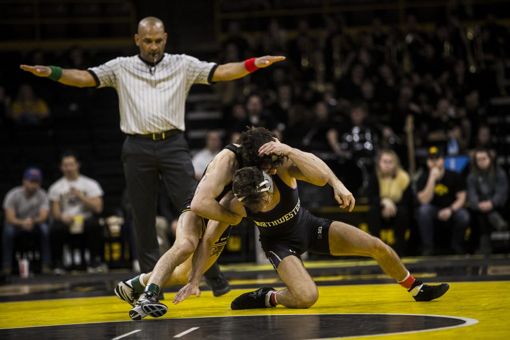 Iowa's 141 pound Vince Turk wrestles Northwestern's Alec Mckenna during the Iowa vs. Northwestern dual meet on Sunday, Feb. 4, 2018. The Hawkeyes defeated the wildcats 33-2. (Nick Rohlman/The Daily Iowan)