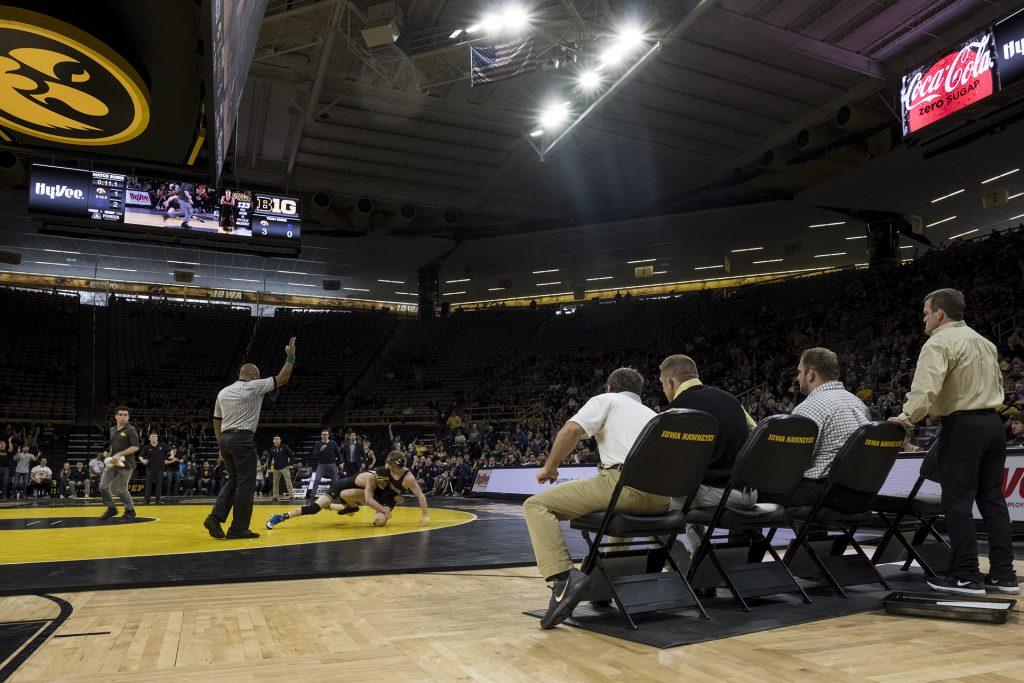 Iowa's coaching staff looks on as 141 pound Vince Turk takes down Alec McKenna during the Iowa vs. Northwestern dual meet on Sunday, Feb. 4, 2018. The Hawkeyes defeated the wildcats 33-2. (Nick Rohlman/The Daily Iowan)