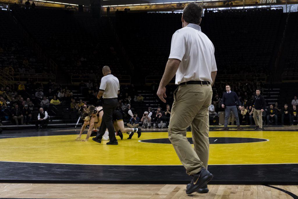 Iowa head coach Tom Brands looks on as Iowa's #2 ranked 149 pound Brandon Sorenson wrestles Northwestern's #5 ranked Ryan Deakin during the Iowa vs. Northwestern dual meet on Sunday, Feb. 4, 2018. The Hawkeyes defeated the wildcats 33-2. (Nick Rohlman/The Daily Iowan)