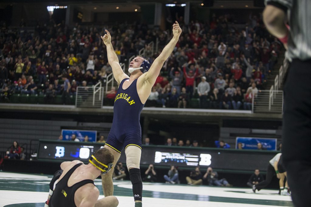 Michigans 165-pound Logan Massa celebrates a victory over Iowas Alex Marinelli during Big Ten Wrestling Championships Day 1 at the Breslin Student Events Center in East Lansing, MI on Saturday, Mar. 3, 2018. (Ben Allan Smith/The Daily Iowan)