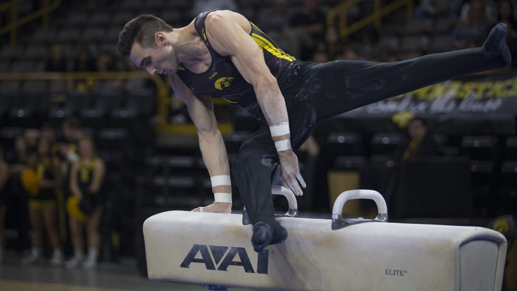 Austin Hodges competes on the pommel during mens gymnastics Iowa vs. Penn State and Arizona State on Mar. 3, 2018 at Carver Hawkeye Arena. Hodges earned a 14.050 for his performance and placed first in this event. The Hawkeyes defeated the Lions and the Sun Devils 404.050 to 396.550 and 376.150. (Katie Goodale/The Daily Iowan)