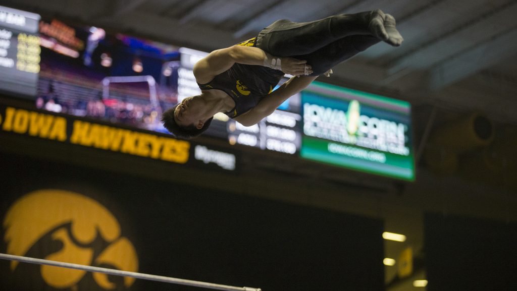 Bennet Huang performs on the horizontal bar during men's gymnastics Iowa vs. Penn State and Arizona State on Mar. 3, 2018 at Carver Hawkeye Arena. Huang earned a 12.750 for his performance.